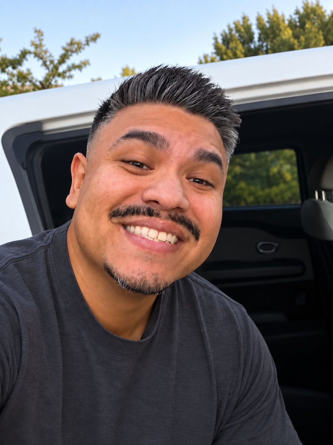Chris smiling in a casual selfie